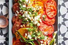 tomatoes and other vegetables are on a tray