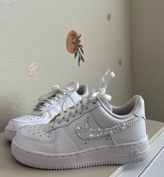 These beautiful embellished pearl Nike Air Force 1 are perfect to walk down the aisle in. They are also perfect for every day occasions to bring a little flare to your outfit. Item Details -Shoes are a White Nike Air Force 1 -You can find the size chart on the Nike website -Embellished with high quality decorative pearls -Super strong industrial jewelry glue is used to ensure that the pearls adhere -Only the check marks will be covered in pearls Elegant Wedding Sneakers With Rhinestones, Wedding White Embellished Sneakers, Elegant Embellished White Sneakers, Elegant Embellished Sneakers For Wedding, Elegant White Embellished Sneakers, White Embellished Sneakers For Party, White Embellished Low-top Wedding Shoes, White Embellished Party Sneakers, Embellished Round Toe Wedding Shoes For Bride