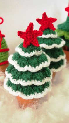 three crocheted christmas trees sitting on top of each other