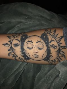 a person with a tattoo on their arm that has sun and moon faces in it