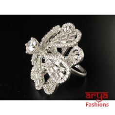 Elegant Cubic Zironia Flower Silver Ring Features: Adjustable Ring to match any finger size Made in Brass with Rhodium finish Lightweight Jewelry Width: 1 Inch Very high quality Cubic Zirconia stones. Suitable for any occasion and traditional or Modern attire Ready to ship and available for local pickup from 23059. Please message us for more details Free shipping on orders above $75 within USA. Diamond White Cubic Zirconia Butterfly Ring For Wedding, Elegant Silver Butterfly Ring With Cubic Zirconia, Wedding Butterfly Ring In Cubic Zirconia, Cubic Zirconia Butterfly Ring For Wedding, Luxury Silver Flower Ring, Elegant Flower Shaped Crystal Ring, Silver Diamond Butterfly Ring For Wedding, Elegant Silver Diamond Butterfly Ring, Silver Diamond Flower Ring For Wedding