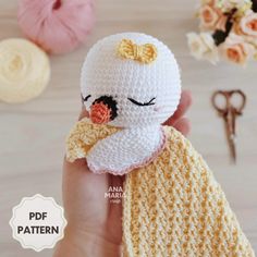 a crocheted doll with a yellow scarf around it's neck and nose