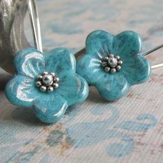 "Tiny Czech glass flowers in your choice of turquoise or antique pink swing from sterling silver French earwires. Accents of sterling silver decorate the center of these easy to wear, fun little earrings. Very cute for spring and summer! Flowers: 5/8\"(16mm)" Turquoise Flower Charm Earrings For Gift, Turquoise Flower Earrings As A Gift, Gift Turquoise Flower Charm Earrings, Gift Turquoise Flower Earrings, Turquoise Nickel Free Flower Earrings, Nickel Free Turquoise Flower Earrings, Turquoise Nickel-free Flower Earrings For Jewelry Making, Turquoise Flower-shaped Earrings With Flower Charm, Turquoise Earrings With Flower Charm