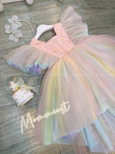 "** Please let a note about your current baby girl age/weight/height in checkout/inbox to help us prepare your order better ! Unique, outstanding and beautiful high low tulle baby girl dress made by Mommiest on theme: \"candy rainbow wonderland\" This dress is perfect for any special occasions such as wedding, birthday, first 1st birthday, party, photoshoots,... Material: tulle, satin, pearls Washing care: Handwash at 20 oC max; Wool spin mode; Iron at 100oC max *This design dress will be handma Whimsical Rainbow Princess Dress For Dress-up, Whimsical Multicolor Princess Dress For Wedding, Multicolor Princess Dress With Ruffles For Birthday, Multicolor Ruffled Tutu Dress For Wedding, Cute Multicolor Princess Dress For First Birthday, Rainbow Ruffled Princess Dress For Party, Rainbow Princess Dress With Ruffles For Party, Multicolor Ruffled Princess Dress For First Birthday, Cute Multicolor Princess Dress For Party