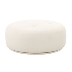 a white round ottoman sitting on top of a table