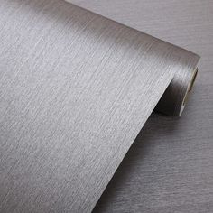 a close up view of a metallic wallpaper with a roll of tape on it