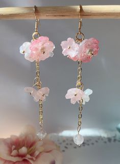 red Sakura Flower Earrings The red sakura flower earrings feature six glazed sakura and one crystal drop. They are really comfortable for everyday wear.  Available in GOLD and Silver finish! M A T E R I A L S * A N D * S I Z E  The hook is 14K gold filled. The pink ball is real quartz stone. - Length: 70mm(without the hook) - Width: 23mm Delicate Dangle Earrings For Spring, Pink Flower Charm Dangle Jewelry, Pink Flower Crystal Earrings For Gift, Delicate Pink Pierced Earrings, Cute Flower Jewelry For Valentine's Day, Charming Pink Flower Jewelry, Charming Pink Flower-shaped Jewelry, Whimsical Dangle Earrings With Flower Charm, Whimsical Dangle Jewelry With Flower Charm