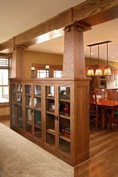 a living room filled with furniture next to a dining room table and bookshelf