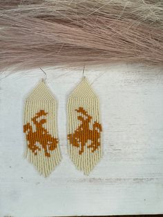 Hand beaded glass bead earrings. Hypoallergenic Hooks Cowboy Beaded Earrings, Artisan White Earrings With Beaded Fringe, Beaded Beige Dangle Jewelry, Beige Beaded Dangle Jewelry, Cream Beaded Dangle Earrings, Cream Beaded Dangle Jewelry, Artisan White Dangling Beads, Beige Dangle Jewelry With Colorful Beads, Adjustable Cream Beaded Earrings