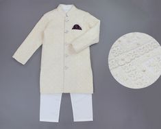 Beautifully hand crafted, this sherwani kurta set will have your little princes fairytale come to life. The jacketis adorned with intricate embroidery work, sequin accents, finished with satin lining on the inside for comfortable wear and a full open button front for easy wear. To complete the look, this Indian/Pakistani long jacket is paired with breathable cotton Kurta and pajama set. Features & Details ►Colors:       Off-White/ Cream with White Kurta Pyjama ►Set of items:       3 piece set in Off White Straight Kurta Sherwani For Festive Occasion, Festive Off White Sherwani With Straight Kurta, Festive Off-white Sherwani With Straight Kurta, Bollywood Style Off White Bandhgala For Festive Occasions, Bollywood Style Off-white Bandhgala For Festive Occasions, Off White Bollywood Bandhgala For Festive Occasions, Festive Off White Straight Sherwani, Fitted Off White Kurta For Transitional Season, Fitted Off White Sherwani With Chikankari Embroidery