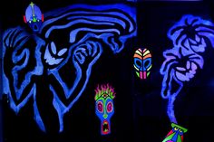 some very pretty paintings on the side of a building in the dark with neon colors