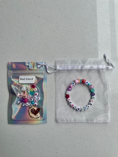 A perfect gift for your little ones bestie! A lovely activity and a very sweet keepsake.  Each kit comes with alphabet beads and a selection of colourful beads.  In the Personalisation bagEach kit includes enough beads to fill your bracelet and a length of clear stretchy bracelet elastic with more than required to allow for the bracelet to be fitted and tied. The kit is labelled and packaged in a holographic sealed bag and their very own material jewellery bag to store their bracelet. Extra tiny Beaded Bracelets Packaging, Bracelet Party Ideas, Packaging For Bracelets, Beads Packaging, Tiny Trinkets, Bracelet Business, Make Your Own Bracelet, Bracelet Packaging, Mini Bracelet