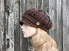 a mannequin head wearing a knitted hat with buttons on the front and side