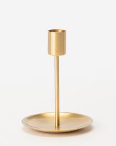 a gold plate with a candle holder on it