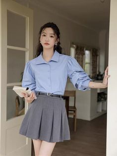 Long sleeved button up shirt with puffy balloon sleeves, tailored bodice and lapel collar. S: 14.5" across shoulders, 37.5" chest, 21" lengthM: 15" across shoulders, 39" chest, 21" lengthL: 15.5" across shoulders, 40.5" chest, 21" length Office Shirt With Puff Sleeves And Button Closure, Workwear Puff Sleeve Padded Blouse, Puff Sleeve Shirt For Work, Puff Sleeve Padded Blouse For Work, Blue Fitted Blouse With Balloon Sleeves, Blue Puff Sleeve Top For Work, Blue Puff Sleeve Top For Workwear, Chic Blue Puff Sleeve Long Top, Blue Puff Sleeve Shirt For Work