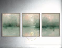 three paintings hanging on the wall in a room