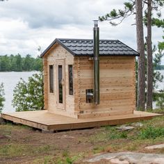 a small wooden cabin sitting next to a lake