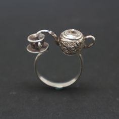 "This unique teapot ring was created and inspired by Victorian Era. Victorian Era was a period of Queen Victoria reign within 20 June 1837 - 22 Jan 1901 in the United Kingdom. During this time, people love to have evening tea with some biscuit before having dinner. This ring was made with 925 Sterling Silver and oxidized to have a antique or vintage feel. Stylish, Unique, Special and Weird ring ever made! Base Material: Sterling Silver Size: 29mm X 10mm (W) (Approximately) Ring Size: US 4 - US 1 Victorian Teapots, Teapot Jewelry, Teapot And Cup, Stile Harry Potter, Dope Jewelry, Funky Jewelry, Gull, Jewelry Inspo, Dream Jewelry