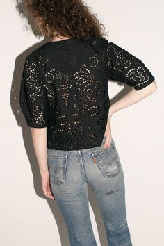 Structured blouse with voluminous short sleeves in an intricate openwork cotton lace. Elegant pleat detail at neck. Semi sheer. Unlined. Made in New York City. Fabric is 100% cotton. Avery is 5'10", bust 31", waist 24", hip 35", and is wearing a size S. Cotton Eyelet Puff Sleeve Tops, Cotton Eyelet Tops With Puff Sleeves, Fitted Broderie Anglaise Short Sleeve Top, Fitted Short Sleeve Top With Broderie Anglaise, Spring Broderie Anglaise Short Sleeve Blouse, Chic Cotton Blouse With Cutwork Hem, Spring Lace Top With Short Sleeves, Fitted Cotton Lace Top With Short Sleeves, Cotton Eyelet Short Sleeve Tops