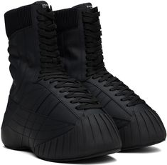 Mid-calf rubberized calfskin boots in black. · Topstitching throughout · Rubber cap toe · Lace-up closure · Logo patch at tongue · Rib-knit collar · Padded jersey lining · Covered platform midsole · Treaded rubber sole · Platform: H2 Supplier color: Noir High-top Winter Boots With Rubber Toe Cap, High-top Boots With Rubber Toe Cap For Winter, Black Stitched Sole Lace-up Boots For Fall, Black Leather Insulated Lace-up Boots, Black Insulated Leather Lace-up Boots, Black High-top Lace-up Boots In Calf Leather, Sporty Winter Boots With Rubber Toe Cap, Winter Streetwear Boots With Rubber Toe Cap, Sporty Black Boots With Rubber Toe Cap