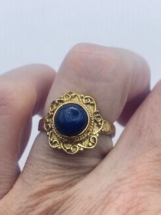 Blue lapis lazuli cocktail ring  Lovely vintage golden bronze setting Size 6.5 Our jeweler can custom re size this for a $20 fee.  All rings are shipped in a nice gift box.   Check out our over a THOUSAND great reviews Engraving is $4 per letter and is not always perfect depending on the piece. It can take a few days if the jeweler is busy. This is payable to Paypal Judithsltd@gmail.com Antique Cabochon Sapphire Ring, Antique Sapphire Cabochon Ring, Antique Round Cabochon Sapphire Ring, Elegant Brass Rings With Cabochon, Blue Brass Ring Jewelry, Gold Victorian Sapphire Ring, Victorian Gold Rings With Birthstone, Sapphire Cabochon Ring As A Gift, Vintage Gold Sapphire Cabochon Ring