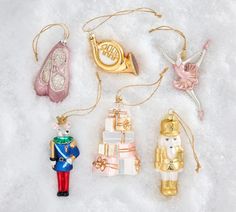 christmas ornaments are laid out in the snow, including nutcracker and other decorations