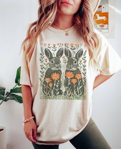 Boho Easter Bunny Shirt, Comfort Colors, Retro Easter Shirt, Floral Bunny Shirt, Graphic Shirt, Bunny Shirt, Wildflowers Rabbit Tshirt  🌸Material: Crafted with 6.1 oz/yd² of premium 100% Ring Spun US cotton, ensuring superior quality and comfort. 🌸Fit: Features a relaxed fit that is both comfortable and stylish, suitable for all genders and sizes. 🌸Collar: Equipped with a topstitched, classic width, rib collar for a timeless and refined look. 🌸Sizing: Runs true to size, providing a consistent and accurate fit. High-quality, stylish pieces and comfortable t-shirts and sweatshirts! Our collection is crafted from premium materials, ensuring a perfect blend of quality and comfort. For our sweatshirts, we use a mix of cotton and polyester, while our t-shirts are available in 100% cotton or Boho Easter, Retro Easter, Easter Bunny Shirts, Bunny Shirt, Easter Shirt, Graphic Shirt, Colorful Boho, Shirt Price, Graphic Shirts