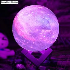 the moon lamp is lit up in purple light