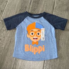 This Boys' Jumping Beans Raglan Tee Gets His Attention With A Blippi Face Graphic! Product Features Crewneck Short, Raglan Sleeves Fabric & Care Polyester, Cotton Machine Wash Face Graphic, Jumping Beans, Raglan Tee, Toddler Boys, Raglan Sleeve, Blue Orange, Kids Shirts, Fabric Care, Baby Toddler