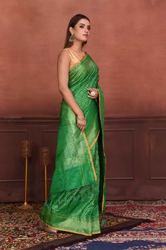 Radiate elegance on festive occasions in this beautiful green Katan silk Banarasi saree with over all zari work. The saree has yellow edging. It comes with a matching blouse piece. Disclaimer: The shown stitched blouse on the model is for display purpose only. The saree comes with a matching blouse piece and finished with fall and piko Disclaimer: The actual product may vary slightly from the image. These are custom orders, hence expect slight variation in color, placement of the motif or buta. Green Pre-draped Saree With Meenakari For Puja, Festive Green Pre-draped Saree With Zari Weaving, Green Semi-stitched Pre-draped Saree With Meenakari, Green Dola Silk Pre-draped Saree For Diwali, Green Pre-draped Saree With Zari Weaving For Diwali, Green Bollywood Pre-draped Saree With Meenakari, Green Paithani Silk Pre-draped Saree With Self Design, Green Chanderi Pre-draped Saree For Puja, Green Pre-draped Saree With Self Design For Diwali