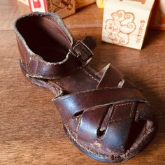 "Adorable vintage little boy's shoes Little brown leather strap sandals. Buckle closure No brand mark or size Measures approximately 5 7/8\" long and 2 5/8\" wide Well worn...vintage charm! Scrapes and scuffs. Vintage condition consistent with age and usage. Cute for a store or shop display, vintage child's room, or vintage vignette. Most of my items are previously owned, used, and loved. These items are rarely in perfect condition and are sold \"as is\". While I do my best to describe each item Vintage Open Toe Sandals With Buckle, Vintage Open Toe Sandals With Buckle Closure, Vintage Closed Toe Sandals For Beach, Vintage Closed Toe Beach Sandals, Vintage Beach Sandals With Buckle Closure, Vintage Brown Sandals With Round Toe, Vintage Brown Closed Toe Sandals, Vintage Closed Toe Sandals, 1950s Boy