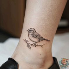 a small bird tattoo on the ankle