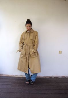 "Timeless vintage Misty Harbor belted ladies' trench coat in a combination of tan with brown trim, buttons up and pockets, and removable straps with buckles on the collar and sleeves, union label proudly states that it's made in the USA. The outer shell comprises 75% Dacron polyester and 25% cotton, nylon lining, Additionally, there's an internal zipper in the coat for an additional lining. In terms of condition, this classic trench coat is in good vintage shape, showing only minor signs of wear. There are a few stains on the inside brown trim; however, these do not affect the overall appeal of this bountiful piece. clean, and ready to wear.   The model is 5'7\" and size S for reference. Approximate size:  M/L - Tag size 16 - please refer to the measurements. M E A S U R E M E N T S -were Trench Coat Vintage, Classic Trench Coat, Brown Trim, Coat Vintage, Brown Belt, Trench Coats Women, Tan Brown, Hippie Boho, Trench Coat