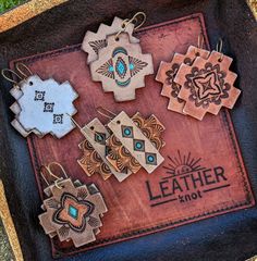 the leather book has many different designs on it