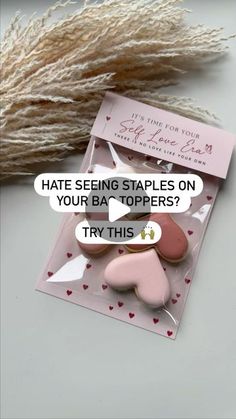 some pink and white heart shaped buttons on top of a piece of paper with text that reads, hate seeing staples on your bag toppers? try this