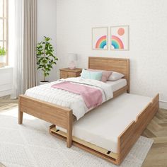 a bed sitting on top of a wooden platform in a bedroom next to a window