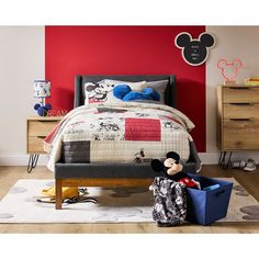 a mickey mouse bedroom with red walls and furniture