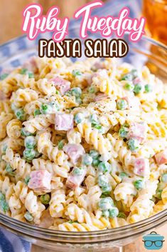 a bowl filled with pasta and peas on top of a table