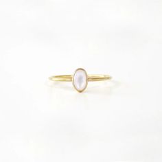 A small, delicate Gold Small Oval Pearl Ring is a delightful, feminine choice. Crafted from eco-friendly recycled gold and a sustainable gemstone, it is the perfect accessory to pair with any Sara Patino Jewelry look. The soft and luminous white pearl offers a timeless beauty that is both classic and modern. Recycled 14k gold filled Mother of Pearl is 6mm x 4mm Oval Pearl Ring, Elegant Oval Stackable Rings For Everyday, Elegant Stackable Rings For Everyday, Elegant Everyday Stackable Oval Rings, Everyday Oval Moonstone Ring, Minimalist Oval Cabochon Wedding Jewelry, Dainty Oval Birthstone Ring For Everyday, Elegant Moonstone Rings For Everyday Wear, Elegant Everyday Moonstone Ring