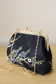 Black and Golden bag for Wedding guest.  Elegance, style and originality are the key parts of these creations. The use of quality materials, advanced know-how are essential values to offer you the best creations. What are you waiting for to sublimate yourself and being original, come to discover our large collection of evening bags. Our collection of Floral golden Black bag made in France.  Bridal clutch for wedding day. Inside French  silk/coton This bag  closed with Kiss-lock frame. - Height5, Elegant Embroidered Rectangular Bags, Elegant Embroidered Rectangular Shoulder Bag, Elegant Embroidered Bags For Ceremony, Gold Embroidered Evening Bag For Gift, Elegant Black Shoulder Bag With Floral Embroidery, Black Pouch Clutch For Wedding, Traditional Black Wedding Bag, Traditional Floral Embroidered Evening Bag, Elegant Embroidered Handheld Bag