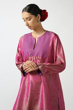 Pink dual toned silk short phiran tunic with contrast thread hand embroidered yoke, bead work highlights and puff sleeves.
Components: 1
Pattern: Hand Embroidered
Type Of Work: Thread and Bead Work
Neckline: Notched Round Neck
Sleeve Type: Puff Sleeves
Fabric: Two Tone Silk
Color: Pink
Other Details: 
Side pockets
Side slits detail
Frill sleeve borders
Note: The pant worn by the model is not for sale
Disclaimer: While the designer strives to recreate every piece as close to what is displayed on Silk Kurta With Embroidered Neckline And Long Sleeves, Embroidered Silk Tunic Kurta, Eid Cotton Silk Kurta With Embroidered Neckline, Traditional Blouse With Embroidered Sleeves, Festive Resham Embroidered Tunic Top, Festive Embroidered Straight Kurta, Designer Embroidered Neckline Tunic Kurta, Designer Embroidered Neckline Kurta Tunic, Cotton Silk Kurta With Embroidered Sleeves