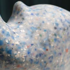 a white bird statue with multicolored sprinkles on it's body