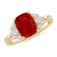 a ring with an oval red stone surrounded by white and yellow diamond accents on the band