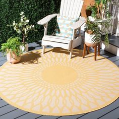 a yellow and white rug sitting on top of a wooden deck