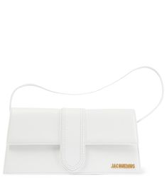 The Le Bambino Long shoulder bag is one of the smartest additions to Jacquemus' family of pint-sized bags. This compact leather design in white has an adjustable strap that can also be styled cross-body, and features golden logo lettering. | Jacquemus Le Bambino Long leather shoulder bag