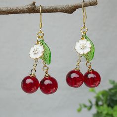 Cherish someone you love, sweet love, pretty girl and vitality are the symbolic meanings of the cherry. Purity and peace are the meanings of this little white flower. These cherry earrings bring sincere blessings to you, either for your own use or as a gift for someone you love. May these earrings brighten up your life. 🙂 All my jewellery is designed and handmade at home. Handmade with love.  🙂 Introducing our stunning handmade earrings, this pair is made from glass cherry, 925 sterling silver hooks, which is hypoallergenic to sensitive skin. The crystallised cherries are wine red colour and very sweet. The overall design is natural and unique, lovely and vibrant. The earrings are brightly coloured and striking for the unique you. Each pair of earrings is carefully handcrafted to ensure Sweet Red Jewelry For Valentine's Day, Cute Red Earrings For Christmas, Retro Earrings For Valentine's Day Gift, Trendy Round Flower Earrings For Gift, Trendy Round Flower Earrings As Gift, Cute Red Christmas Earrings, Cute Cherry Dangle Jewelry, Cherry Colored Earrings Gift, Cute Red Dangle Jewelry