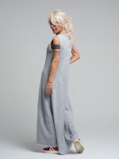 Our grey maxi dress is the epitome of laid-back chic, made from soft viscose that drapes beautifully for a comfortable yet stylish look. Its sleeveless design and subtle scoop neckline offer a casual elegance that's perfect for sunny days or layered under a jacket when the evening cools down. FEATURES:Sleeveless with a relaxed fit and a long, flowing silhouette. Ideal for leisurely weekend wear or as a base for accessorizing100% Handmade. SIZE & FIT: Fit: A relaxed fit with room to moveModel is wearing size Small or S/M View our SIZE CHART before ordering MATERIALS & CARE: Content: 65% Cotton, 35% Polyester Care: Machine wash on cold (30ºC) with a mild detergent. SHIPPING: Made to order, the processing time is 15 working days This item will be shipped via DHL Casual Sleeveless Maxi Dress For Loungewear, Casual Gray Sleeveless Maxi Dress, Sleeveless Gray Maxi Dress For Spring, Gray Floor-length Maxi Dress, Chic Gray Maxi Dress, Grey Maxi, Stocking Fillers For Her, Grey Maxi Dress, Dresses Xxl