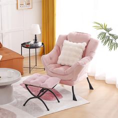 a pink chair and ottoman in a living room