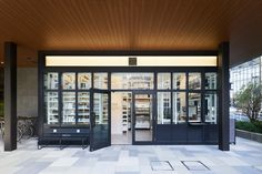 the entrance to a large building with lots of glass doors and windows on both sides