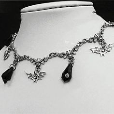 Add a touch of dark elegance to any outfit with our Gothic Victorian Pendant Choker Necklace. The intricate design and choker style make this necklace a unique and stylish addition to your jewelry collection. Stand out from the crowd with this must-have accessory! Metal Halloween Choker Jewelry, Halloween Metal Choker Jewelry, Gothic Dangle Necklaces For Parties, Gothic Metal Dangle Necklaces, Gothic Pendant Jewelry With Clavicle Chain, Gothic Chain Jewelry For Evenings, Elegant Silver Dangle Choker, Gothic Pendant Necklace For Party, Gothic Metal Clavicle Chain Choker